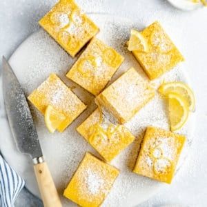 lemon squares on a plate with a knife