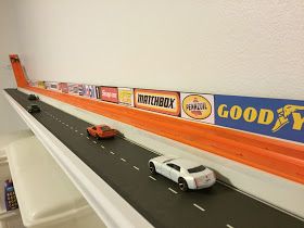 there are cars driving down the highway with good value signs on each side and an orange line across the road