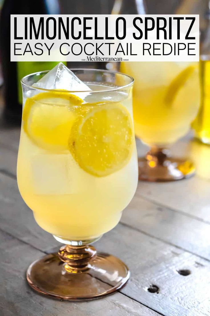 two glasses filled with lemonade sitting on top of a wooden table