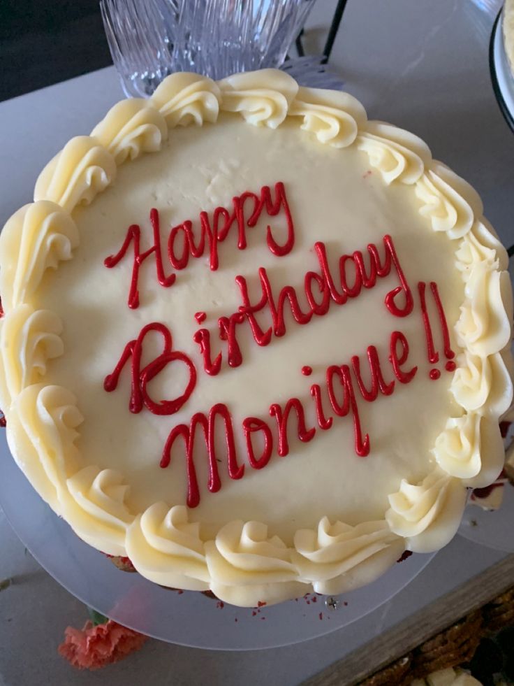 a birthday cake with the words happy birthday morrique written in red on it