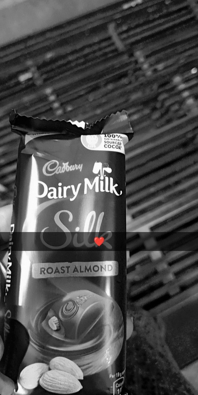 a bag of dairy milk sitting on top of a bench