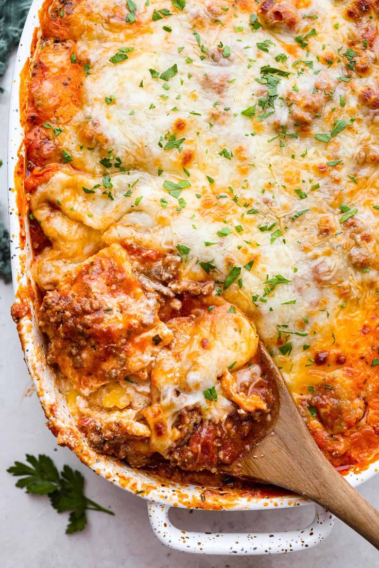 a casserole dish with meat, cheese and parmesan sauce on top