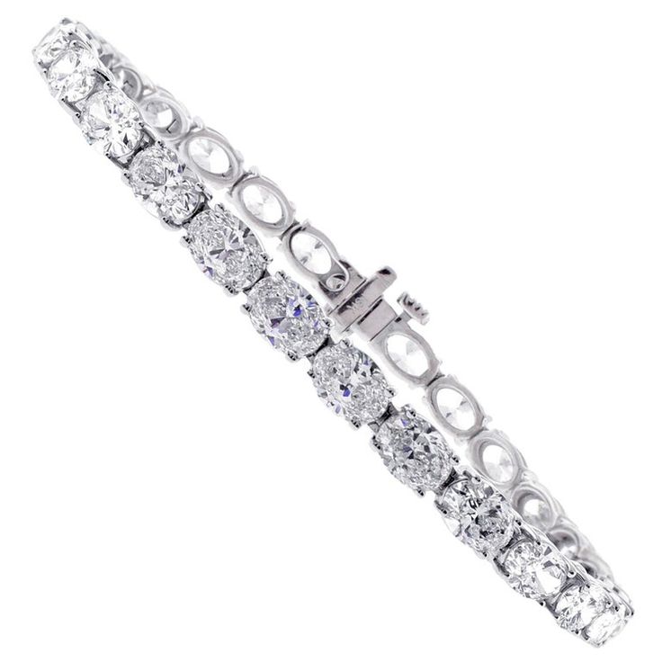 From Pampillonia jewelers, 27 perfectly matched oval diamonds lined up end to end form a straight line of diamonds. The 27 diamonds weigh 11.50 carats and are E-F color and are VS2+ clarity, set in 18 karat white gold. The bracelet is 6 ¾ inches and is available in any length. Pampillonia custom creates diamond bracelets in a variety of diamond shapes and sizes Luxury Oval Tennis Bracelet In Fine Jewelry Style, Luxury Oval Cubic Zirconia Bracelet, Oval Bracelet Diamond, Diamond Tennis Bracelet With Oval Link And Accents, Oval Link Diamond Tennis Bracelet With Diamond Accents, Oval Link Diamond Tennis Bracelet With Accents, White Gold Diamond Tennis Bracelet With Oval Links, Oval Diamond White Diamond Bracelet For Anniversary, Classic Oval Diamond White Tennis Bracelet