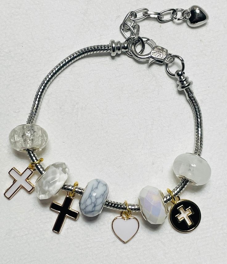 These European charm bracelets are one of a kind This listing is for 1 bracelet. Great for stacking! **MORE STYLES COMING SOON** Bracelet is approximately 7.9inches long/ average adult size. Including link it adds 2 more inches to the bracelet.   [CARE TIPS   -To keep your item lasting longer avoid contact with water, lotions and any other liquids. Everyday Spiritual Charm Bracelet, Adjustable White Metal Charm Bracelet, Personalized Adjustable White Charms, Personalized White Adjustable Charms, Adjustable White Charm Bracelet With Lobster Clasp, White Metal Bracelets With Charms, White Metal Bracelet With Charms, White Dangle Charm Bracelet, White Metal Dangle Charm Bracelet