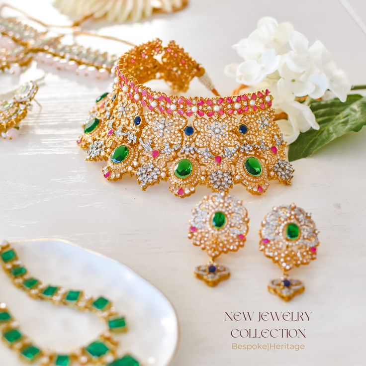 Indulge in luxury and make a statement that transcends time with this resplendent set! A dazzling blend of opulence and elegance promises to elevate your style with its enchanting design rendered in gleaming sapphire, emerald, and ruby stones, meticulously crafted in addition to lustrous pearl moti to add a touch of classic charm, creating a harmonious balance between tradition and contemporary allure to ensure you shine with unparalleled grace. The set includes a necklace and a pair of stylish