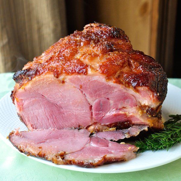 ham on a white plate with parsley