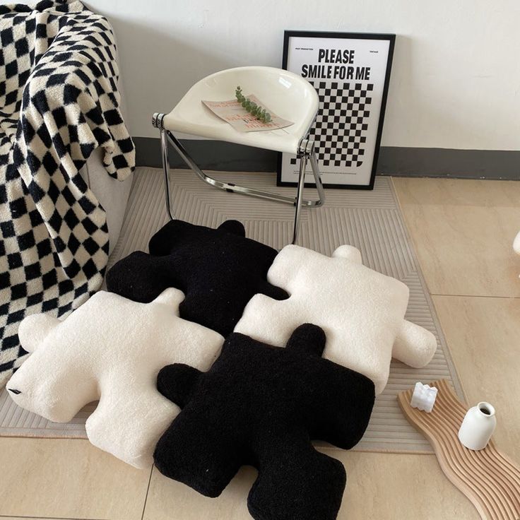 black and white rugs are on the floor next to a chair