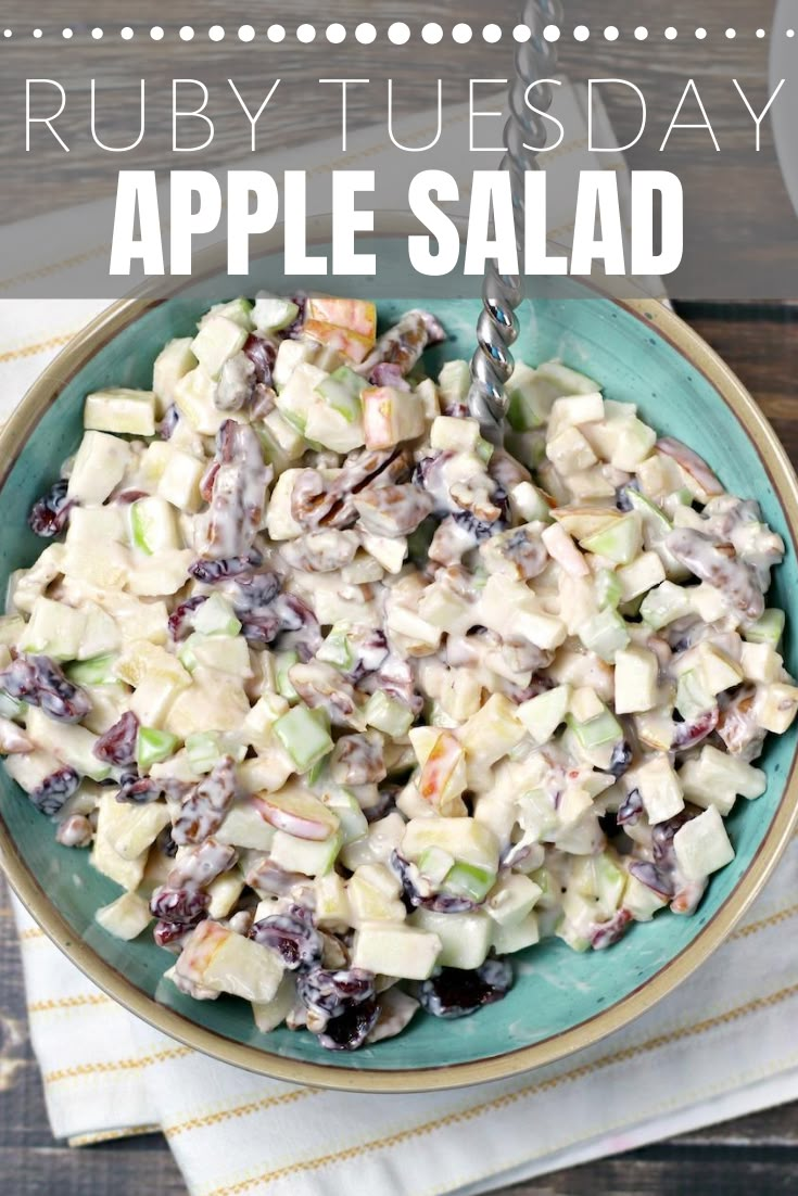 a blue bowl filled with salad on top of a wooden table