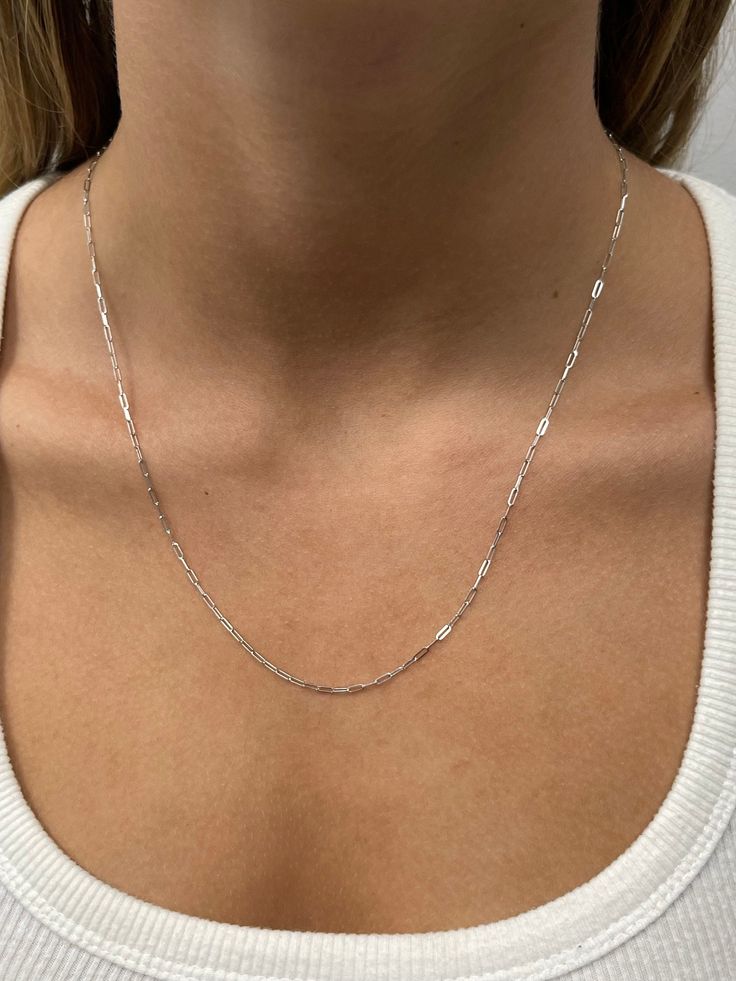 "➣ High quality Solid 14K White Gold 1.5mm Adjustable Paperclip Chain with Lobster Lock, 22\" Long, Set Your Own Length, Real Gold Necklace, Women ➣ MATERIAL: 14K White Gold  ➣ Closure: Lobster claw   ➣ Solid / Hollow: Solid  ➣ Weight: 2.60g ◈ Please note that weights are approximate. ➣ If you need a specific length, please message us. ➣ SHIPPING: ◈ We always offer domestic FREE SHIPPING via USPS first class (3-5 business days)  ◈ We ship internationally, shipping costs are shown at checkout.     Please be aware that the buyer is responsible for any international customs & duties. ◈ Orders shipped from NYC usually within 24-48 hours from receiving payment.   ◈ All orders are packaged in a gift box at no additional cost. ➣ Return / Exchange policy: ◈ Your satisfaction is important to us! Se White Gold Jewelry With Rectangular Links As A Gift, White Gold Jewelry With Rectangular Links For Gifts, Sterling Silver Delicate Paperclip Chain Necklace, Sterling Silver Delicate Chain Necklace Paperclip Shape, Sterling Silver Box Chain Necklace, Sterling Silver Figaro Chain Necklace With Rectangular Links, White Gold Figaro Chain Necklace With Rectangular Links, White Gold Oval Link Jewelry With Figaro Chain, Fine Jewelry Box Chain Necklace With Oval Link