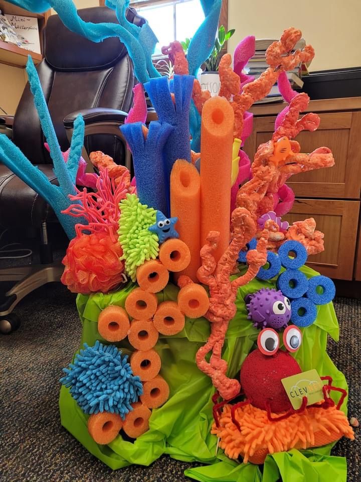 an arrangement of fake corals and seaweed on a table