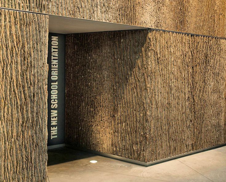 an open door on the side of a building that is made out of tree bark