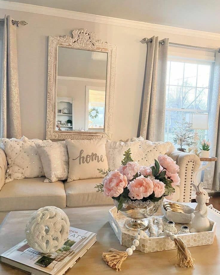 a living room filled with lots of furniture and flowers on top of a coffee table