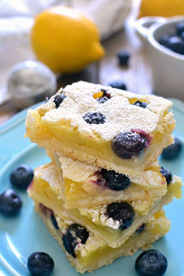 a stack of lemon blueberry bars on a plate