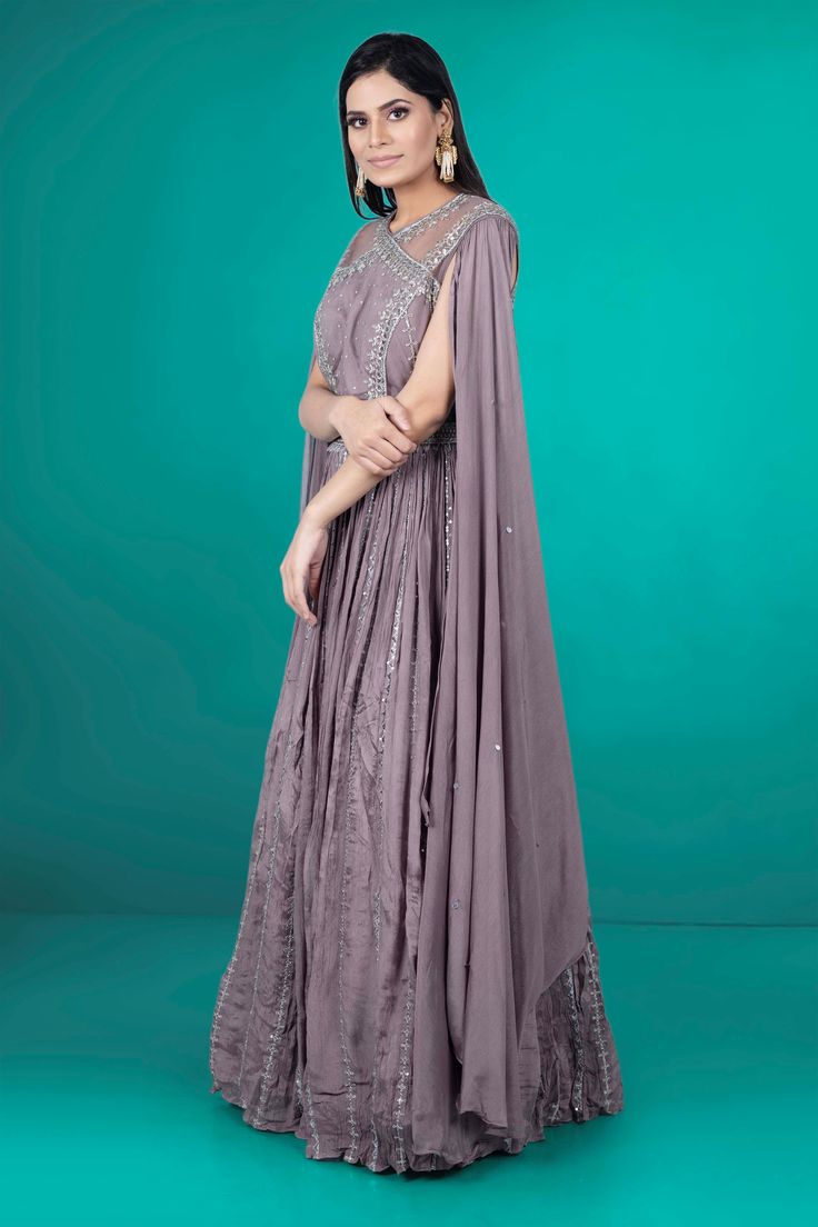 Get ready to be the center of attention at any party with our PartyWear Anarkali-034. This stunning piece features intricate stone work and sequence details, adding a touch of elegance and sparkle to your look. Make a statement and stand out from the crowd in this one-of-a-kind Anarkali. Anarkali Gown With Cape Sleeves And Resham Embroidery, Anarkali Gown With Cape Sleeves For Reception, Hand Embellished Unstitched Anarkali Set, Hand Embellished Anarkali Set, Anarkali Set With Resham Embroidery And Cape Sleeves, Anarkali Traditional Wear With Resham Embroidery And Cape Sleeves, Floor-length Mirror Work Anarkali Set For Reception, Bollywood Style Hand Embellished Floor-length Salwar Kameez, Silver Anarkali Salwar Kameez For Designer Wear