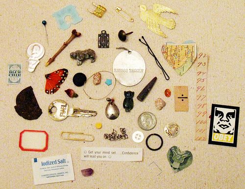 there are many different items on the table together, including brooches and pins