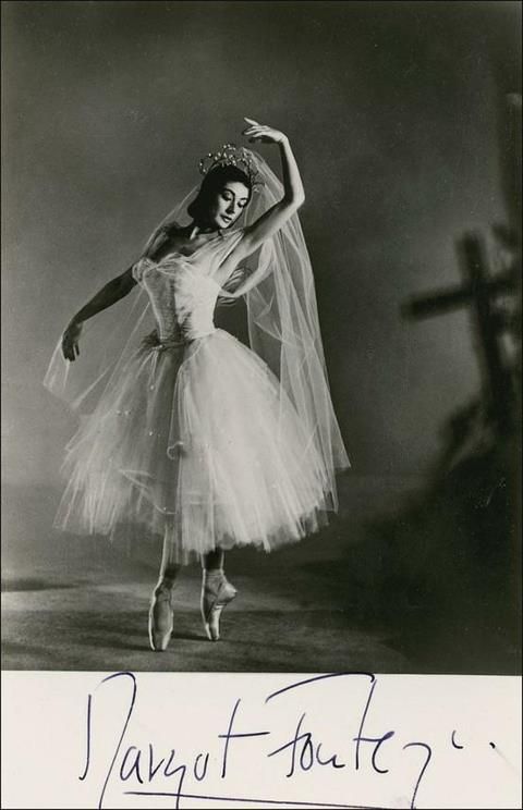 a black and white photo of a woman in a tutu with her arms outstretched