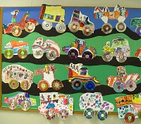 a bulletin board with lots of magnets on it and cars hanging from the wall