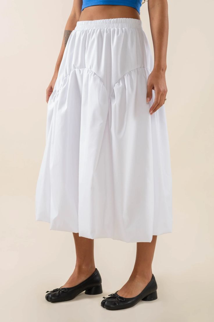 Bubble hem poplin midi skirt Elastic waistband Arched yoke Bubble shaped hem Midi length Fabric is a polyester/cotton poplin Make it a set with our Faye Bubble Crop Poplin Tube Top! Fit (Measurements taken from size S) Waistband (Relaxed): 27"  Hips: 44" Total length: 30 1/2" Iyana is 5'7" and wearing size S  View full Chic Midi Dress With Ruffles, Casual Midi Length Skirt With Gathered Waist, Chic Midi Bottoms With Gathered Waist, Casual Midi Skirt With Gathered Waist, Spring Midi Skirt With Gathered Waist, Spring Skirted Bottoms With Gathered Waist, Casual Bottoms With Gathered Waist, Midi Length, Casual Midi-length Bottoms With Gathered Waist, Midi Skirt With Gathered Waist For Daywear