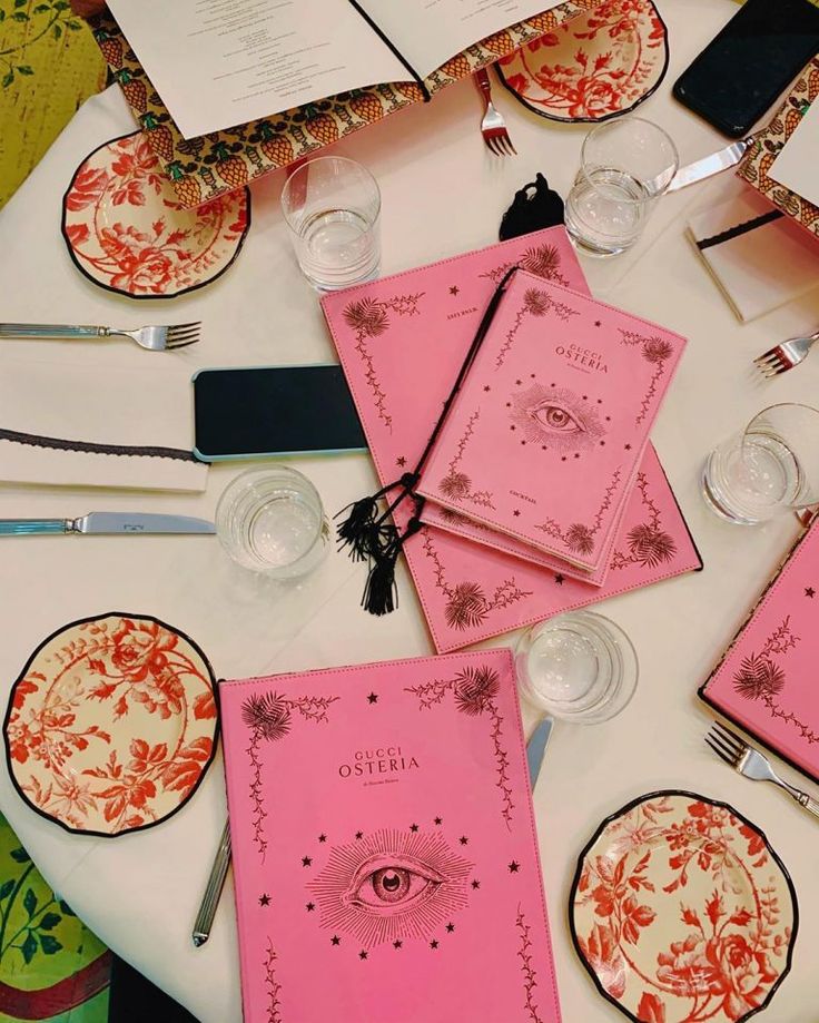 the table is set with pink napkins and place settings for an eyeball themed party