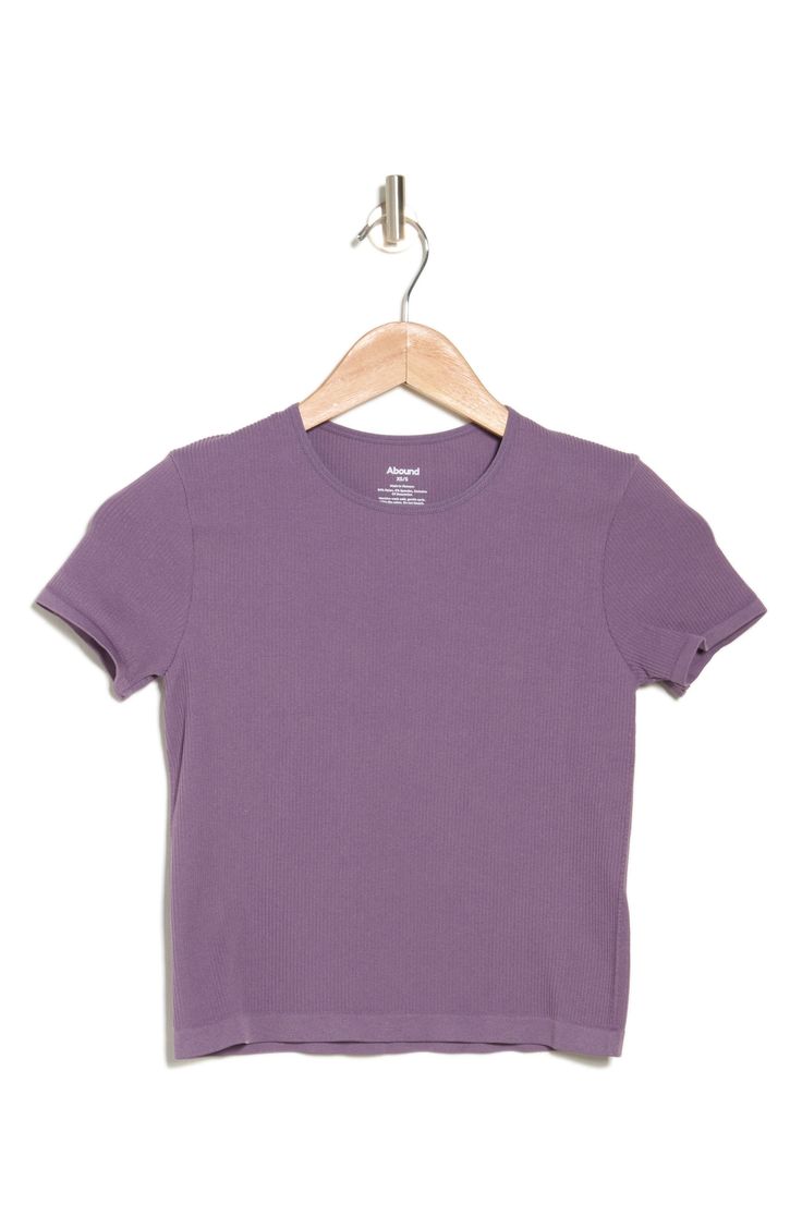 An essential for endless outfits, this baby tee is made from stretchy ribbed fabric that creates a figure-hugging fit. Crewneck Short sleeves 93% nylon, 7% spandex Machine wash, line dry Imported Fitted Basic Ribbed T-shirt, Basic Seamless Snug Fit T-shirt, Basic Solid Stretch T-shirt, Basic Ribbed Short Sleeve Top, Seamless Snug Fit Short Sleeve Top, Solid Ribbed T-shirt For Layering, Basic Snug Fit Seamless T-shirt, Basic Solid Cropped T-shirt With Ribbed Detail, Stretch Top With Ribbed Neckline And Short Sleeves