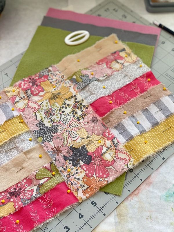 a close up of a piece of fabric on a table next to a ruler and scissors