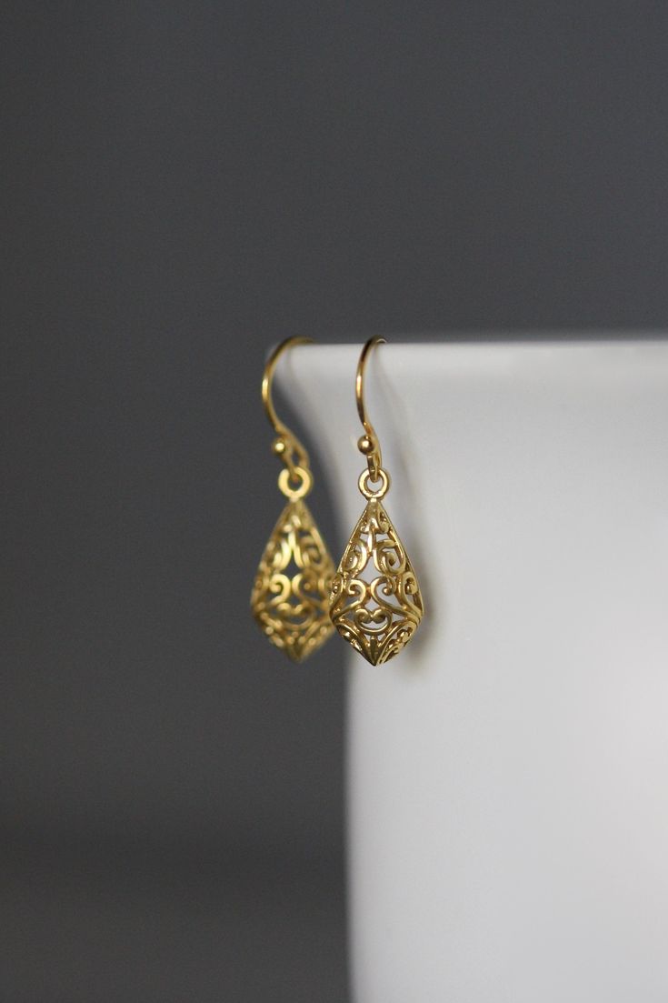 "24k matte gold vermeil filigree charms dangle from 18k gold vermeil balled earwires. Wear these elegant earrings everyday as they complete any outfit. Gold filigree charms: 9x19mm Total length of earrings: 1 1/8\" All gold is gold vermeil. This earrings are available in bright silver... www.etsy.com/listing/630528036/silver-filigree-earrings These earrings are also available in oxidized silver... www.etsy.com/listing/688867970/silver-filigree-earrings As the owner, maker, designer, and curator Gold Plated Filigree Teardrop Jewelry, Teardrop-shaped Gold Plated Filigree Jewelry, Gold Teardrop Earrings With Intricate Design, Gold Teardrop Earrings With Intricate Design As Gift, Gold Hypoallergenic Brass Teardrop Earrings, Hypoallergenic Gold Teardrop Brass Earrings, Hypoallergenic Gold Teardrop Earrings In Brass, Gold Earrings For Anniversary With Ear Wire, Gold-plated Hypoallergenic Teardrop Earrings