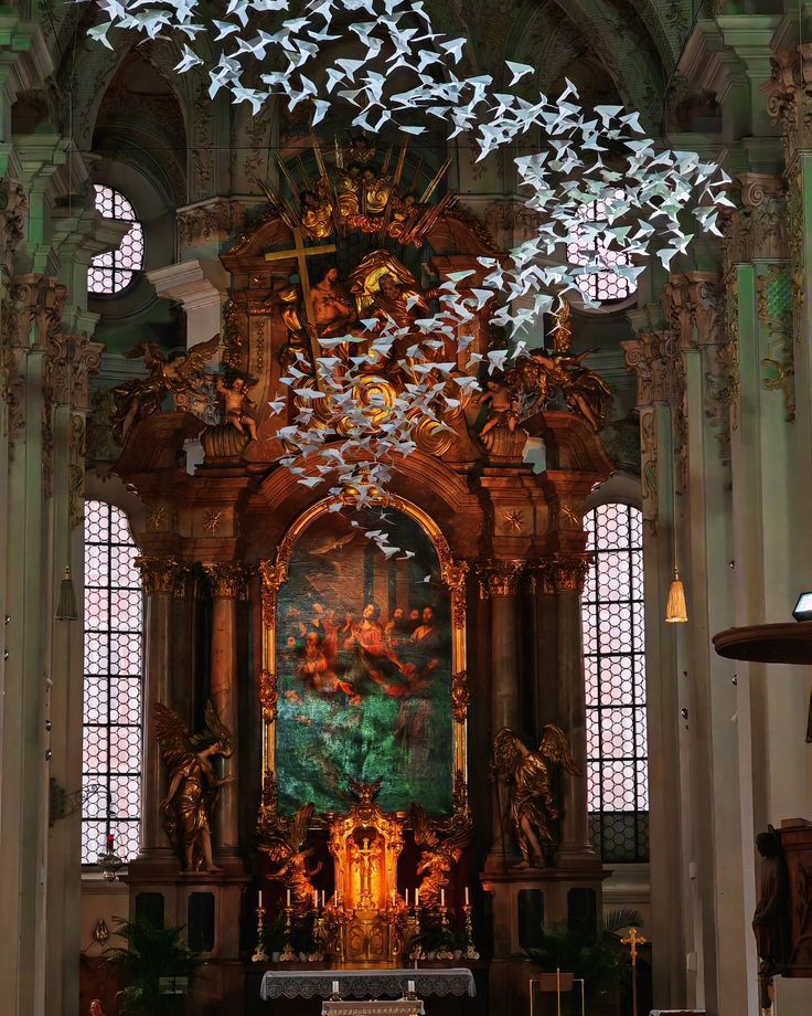 the interior of a church with many birds flying overhead