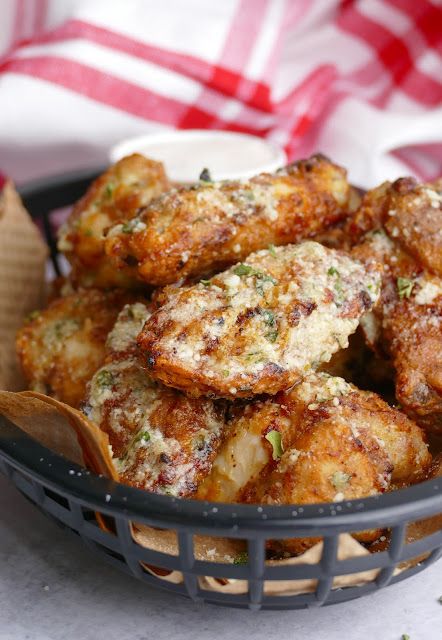 a basket filled with fried food sitting on top of a table