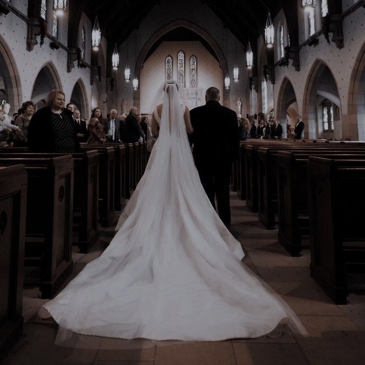 a bride and groom walking down the aisle at their wedding ceremony in an old church