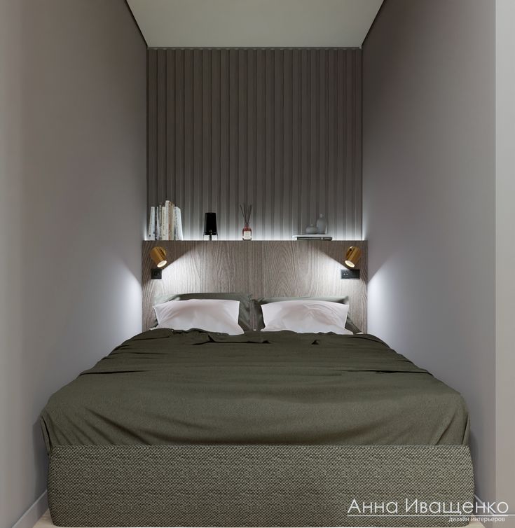 a bed with two lamps on either side of it