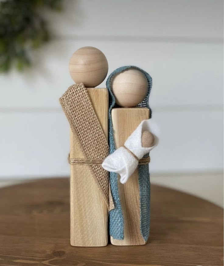 two wooden pegs are standing next to each other on top of a wood table