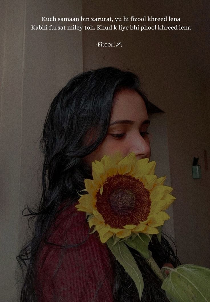 a woman holding a sunflower in her hand with a quote on the back ground