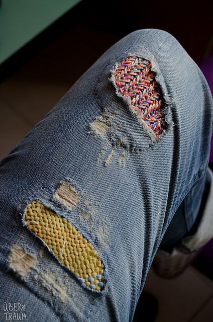 the jeans are ripped with colorful sprinkles and holes in them, but they still have some wear on them