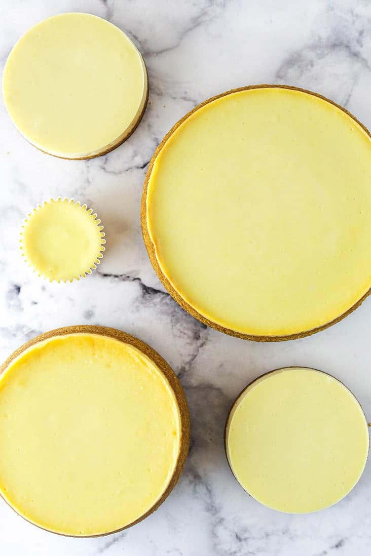 three pies sitting on top of a white marble countertop next to each other