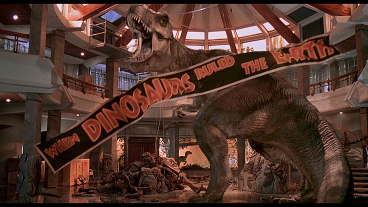 an image of a dinosaur with a banner in it's mouth that says dinosaurs raid the planet