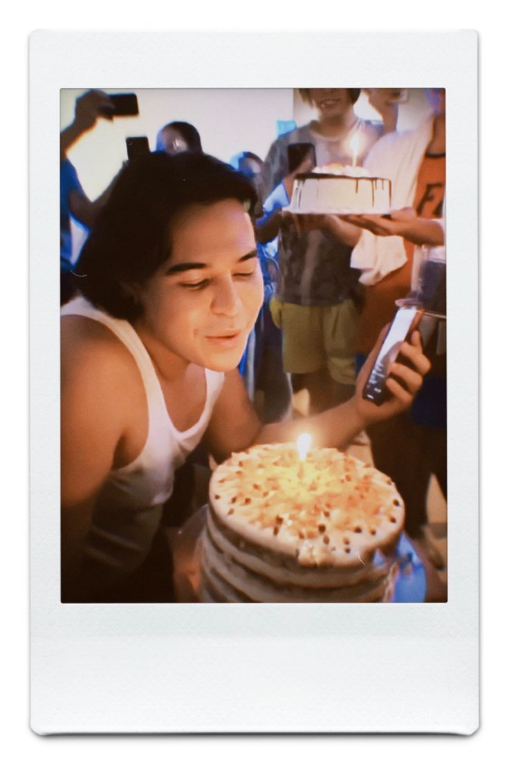 a woman blowing out the candles on a cake