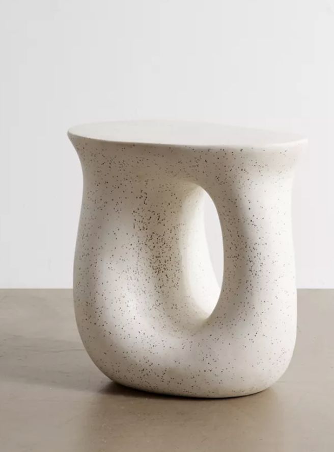 a white vase sitting on top of a table