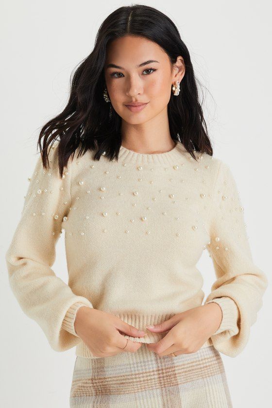 The Lulus Undeniable Glow Ivory Pearl Pullover Sweater will be your favorite way to make yourself shine this holiday season! This stunning sweater has a slightly fuzzy medium-gauge knit construction, with gleaming faux pearl details throughout, that shapes a classic crew neckline, long balloon-style sleeves with fitted cuffs, and a relaxed bodice. Contrasting ribbed knit accents the neckline, cuffs, and hem. Fit: This garment fits true to size. Length: Size medium measures 17.75" from shoulder t Pearl Sweater Outfit, Sweaters For Women Knit, Fancy Sweater, Pearl Sweater, Rhinestone Sweater, Black Ivy, Chic Clothing Style, Trendy Cardigans, Christmas Fits