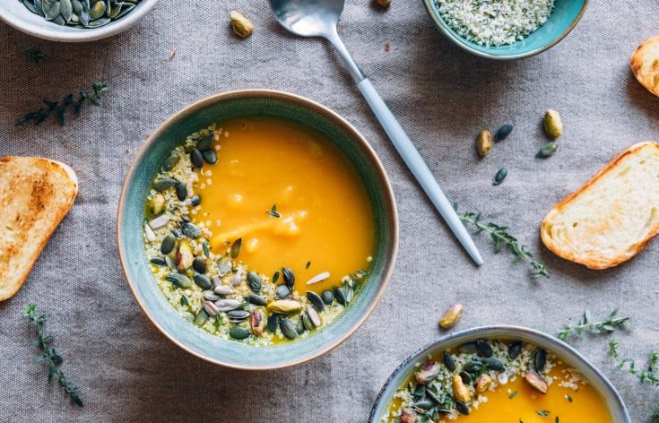 bowls of soup and bread on a table