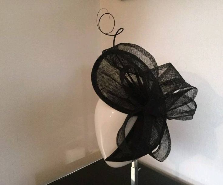 Stunning handmade black sinamay fascinator ideal for weddings, high tea events, races, or funerals. It is secured in place using a hat elastic. I can make this in any colour of your choice. Please allow 5 working days for postage. For postage outside the UK - postage prices vary. Please contact me before purchasing for postage quote. Thank you for looking ** Please note: This fascinator is made to order so I cannot issue a refund. Ivory Fascinator, Royal Ascot Races, Blue Fascinator, Royal Ascot Hats, Black Fascinator, Bride Hat, Ascot Hats, Tea Party Hats, Feather Fascinators