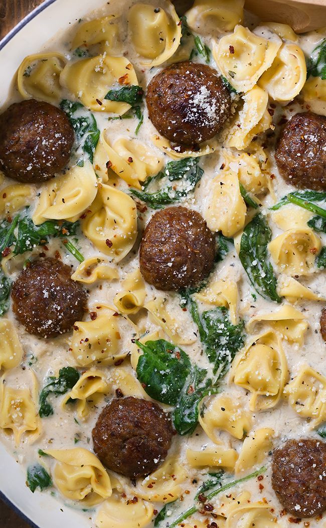 a white bowl filled with pasta and meatballs