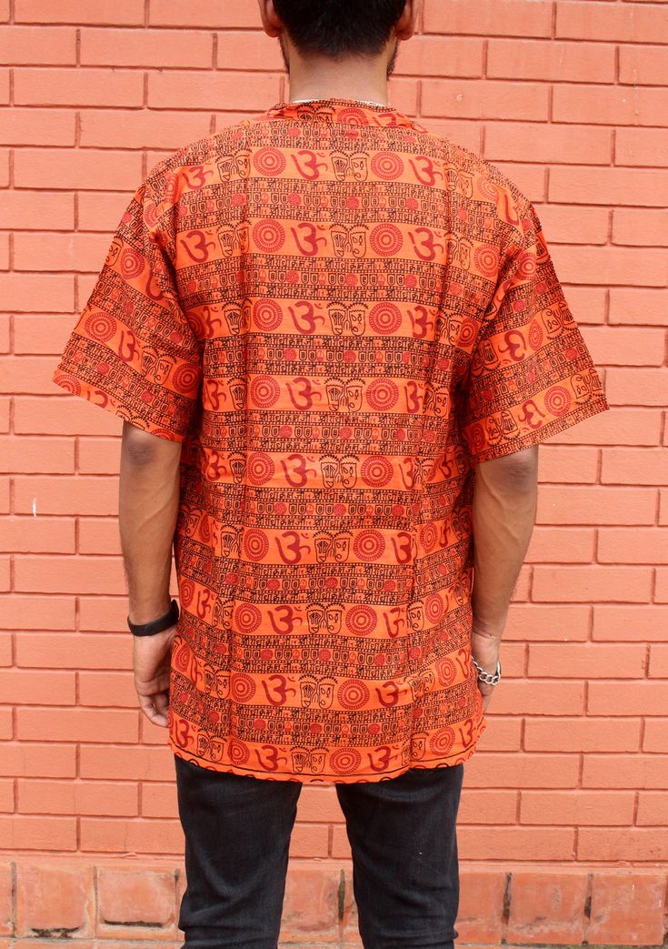 Traditional Crew Neck Cotton Shirt, Traditional Cotton Crew Neck Shirt, Traditional Relaxed Fit Cotton Shirt, Orange Relaxed Fit Printed Shirt, Cotton Relaxed Fit Top For Meditation, Orange Relaxed Fit Cotton Camp Shirt, Traditional Short Sleeve Printed Blouse, Orange Printed Short Sleeve Tops, Festival Printed Short Sleeve Shirt