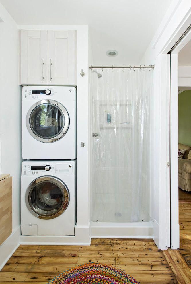 a washer and dryer in a room with wood flooring on the ground