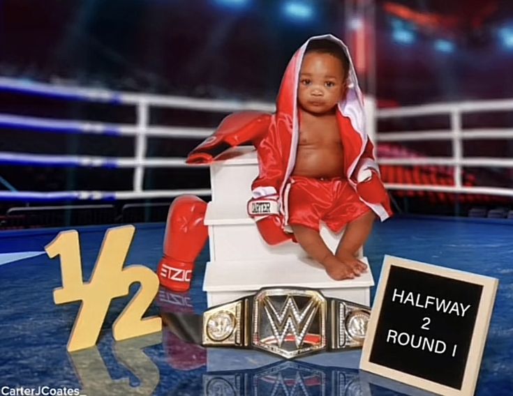 a baby sitting on top of a chair next to a plaque