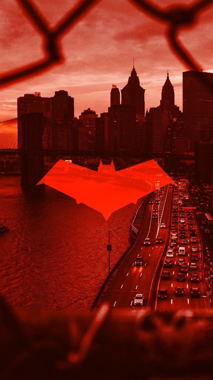 an orange umbrella on the side of a bridge over a river with cars driving down it