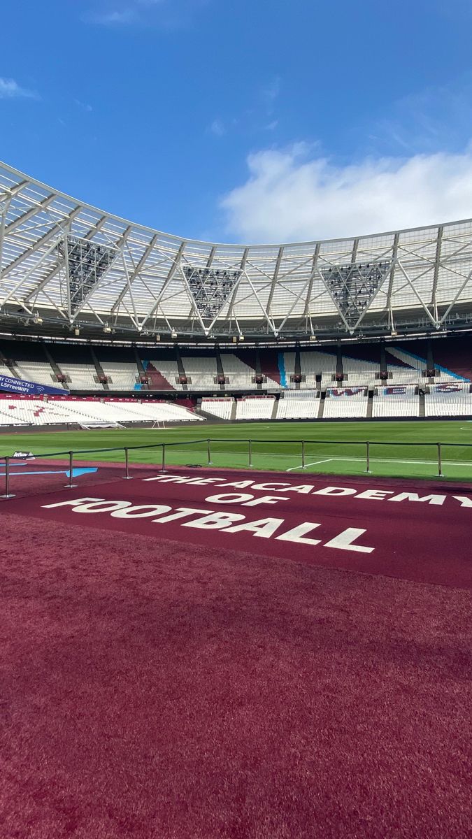 an empty soccer stadium with red turf