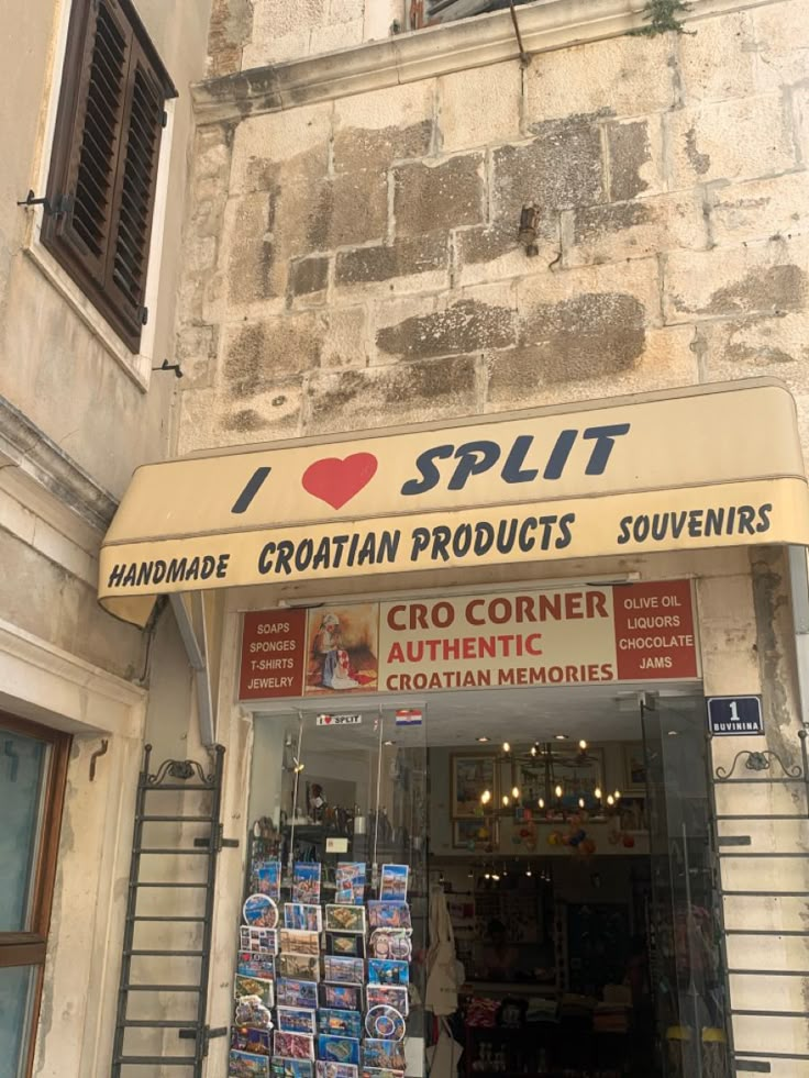 an old building with a sign that says i love split croatia products souvenirs