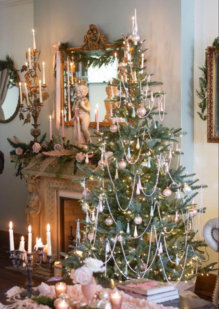 a decorated christmas tree in front of a fireplace with candles and ornaments on the mantle