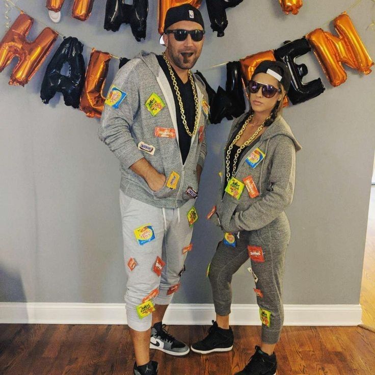 a man and woman standing next to each other in front of balloons that spell out i love you