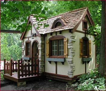 a small house made out of rocks in the woods